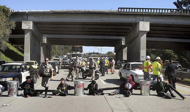 In this file image from earlier this week, University of California Santa Cruz students block traffic to protest tuition hikes, Tuesday, March 3, 2015, in Santa Cruz, Calif. Photo: Dan Coyro, Associated Press 