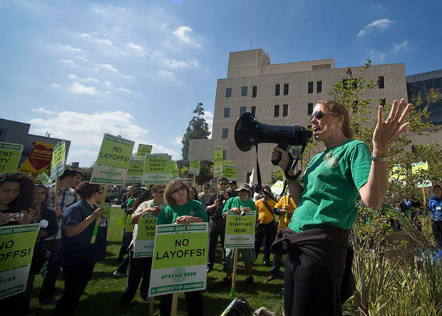 AFSCME Local 3299 President Kathryn Lybarger speaks to the crowd on Tuesday, as more than 200 union members, health care workers, students and some family members rally outside UC Irvine Medical Center in Orange to protest the 175 layoffs of nurses, emergency trauma staff, and psychiatry, radiology and other health care workers. (Photo by Cindy Yamanaka, Orange County Register/SCNG) 