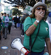 UCSF patient care assistant Cynthia Ciera (left) and hospital service coordinator Agnes Suarez (right) rally with UCSF Medical Center colleagues. Photo: Liz Hafalia, The Chronicle 