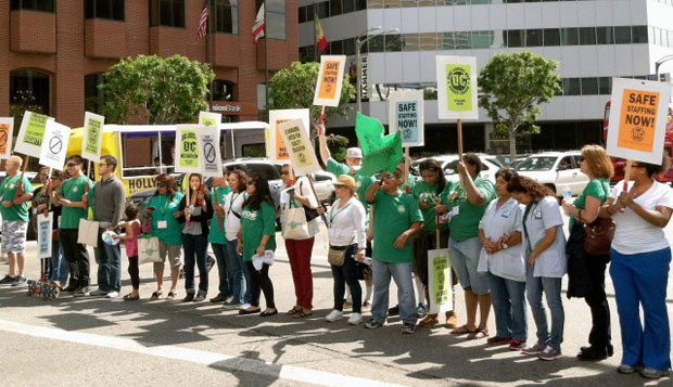 Union workers and supporters blocked traffic at the intersection of Westwood Boulevard and Wilshire Boulevard on Friday to protest the University's recent contract offer. Kristen Taketa / Daily Bruin
