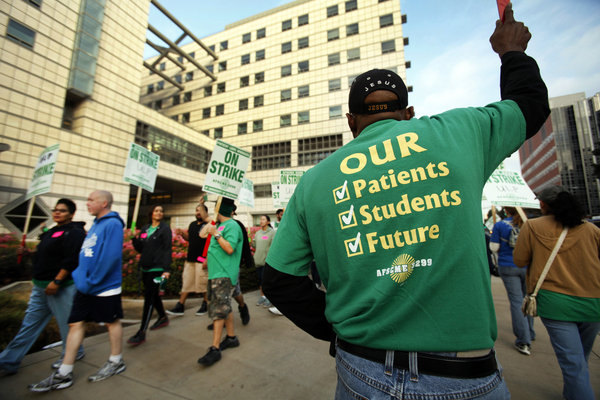 Alfred Rogers, right, a cardiovascular technologist, joins strikers Wednesday morning in front of the Ronald Reagan UCLA Medical Center. The one-day strike affected UC facilities throughout the state. (Al Seib / Los Angeles Times / November 20, 2013)