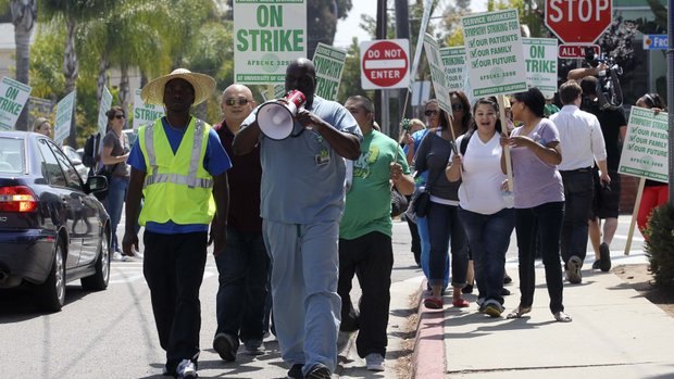Union workers walk the picket line at UC San Diego Medical Center Hillcrest in May. — John Gibbins