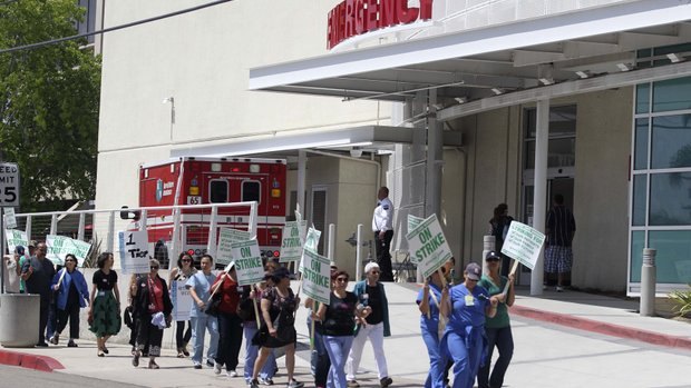 AFSCME Local 3299 workers walk the picket line in May at UC San Diego Medical Center in Hillcrest. — John Gibbins