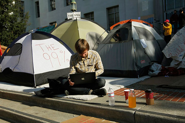 A graduate student grades essays on his computer on the campus of UC Berkeley in 2011.